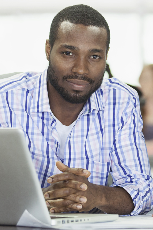 Photo of young male working at a desk